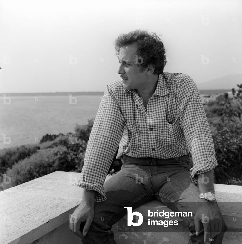 Domenico Modugno sitting on a wall
