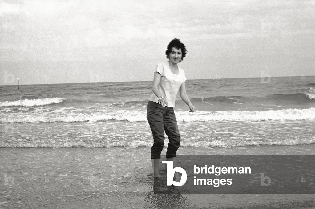 Gina Lollobrigida on the seashore, 1956 (b/w photo)