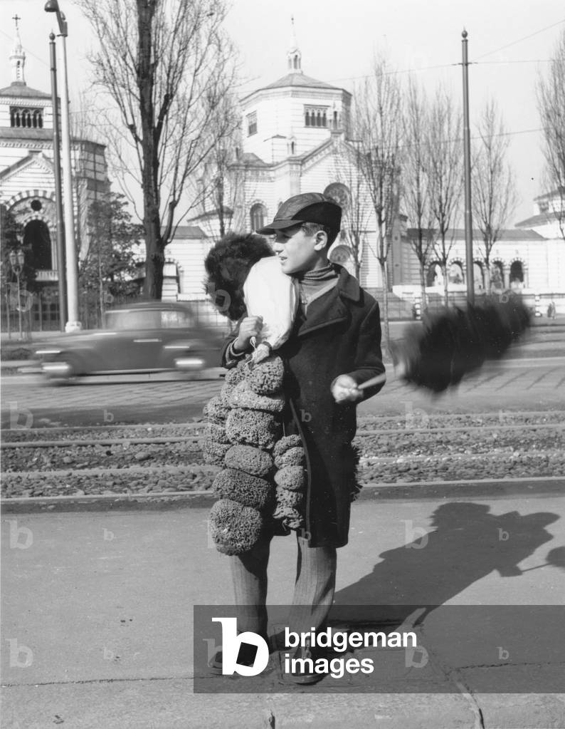 A boy selling sponges and dusters, Italy, 1950 (b/w photo)
