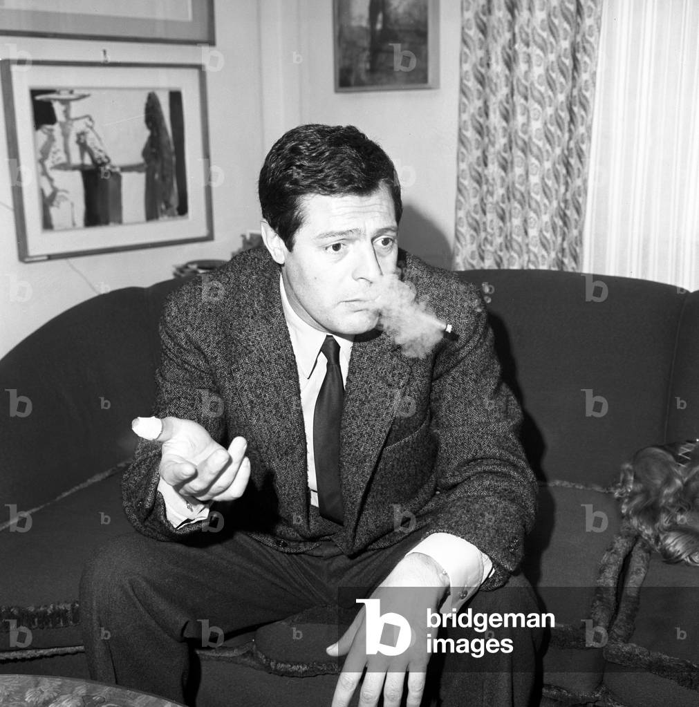 Marcello Mastroianni smoking during an interview, Italy, 1963 (b/w photo)