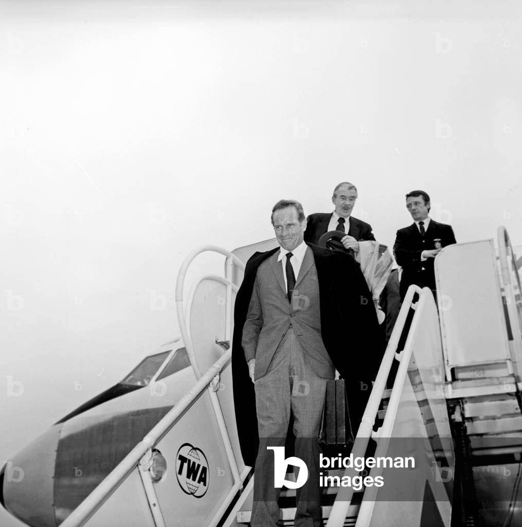 Charlton Heston arriving at Fiumicino Airport, Fiumicino, Italy, 1960 (b/w photo)