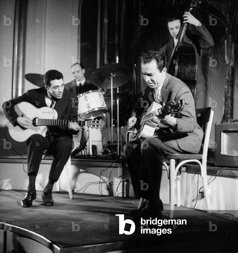 Two jazz guitar players performing on stage