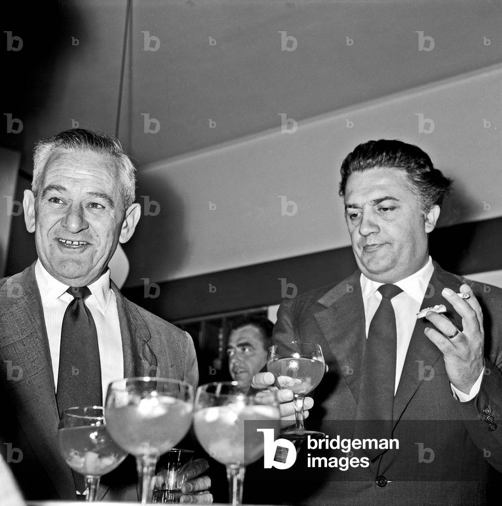 William Wyler and Federico Fellini at the cocktail party for the film 'Ben Hur', Rome, Italy, 1958 (b/w photo)