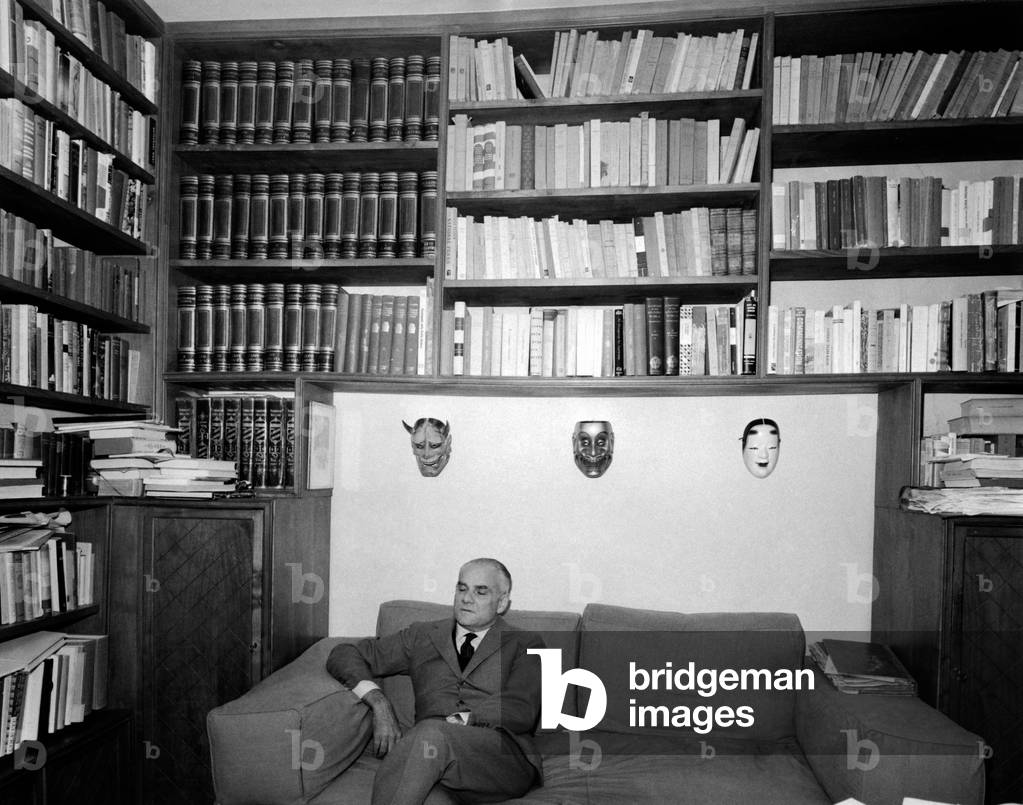 Writer Alberto Moravia sits on a sofa, Rome, Italy, 1961