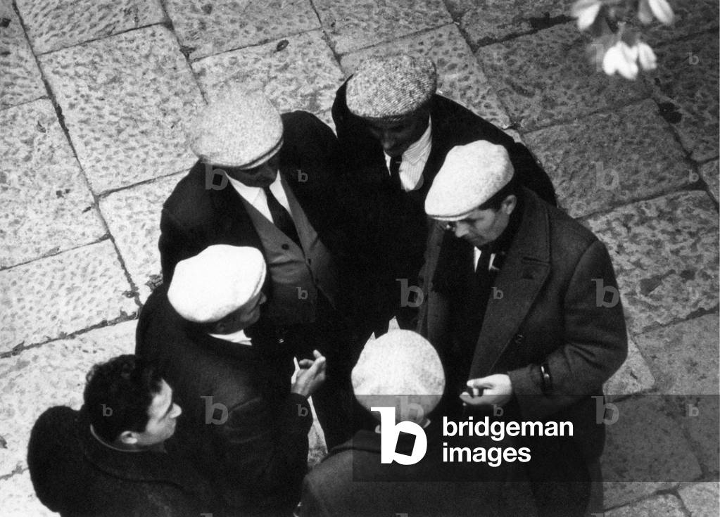 View from above of a group of men talking together, Trapani, Italy