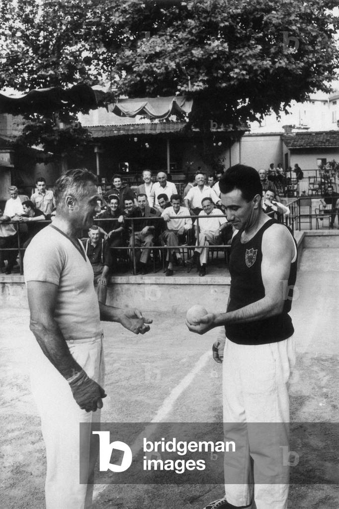 Two bocce players in the court of Alba, Alba, Italy