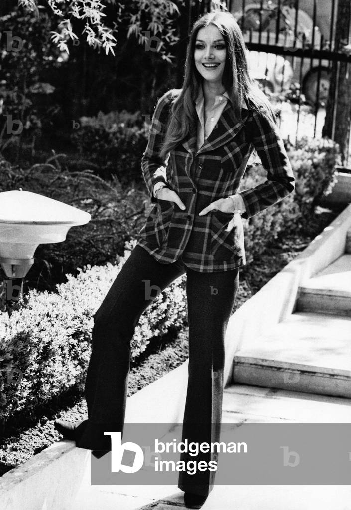 Portrait of a smiling Barbara Bouchet in the garden