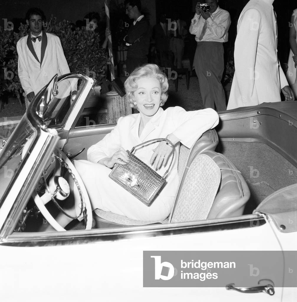 Marlene Dietrich in a car, Italy, 1956 (b/w photo)