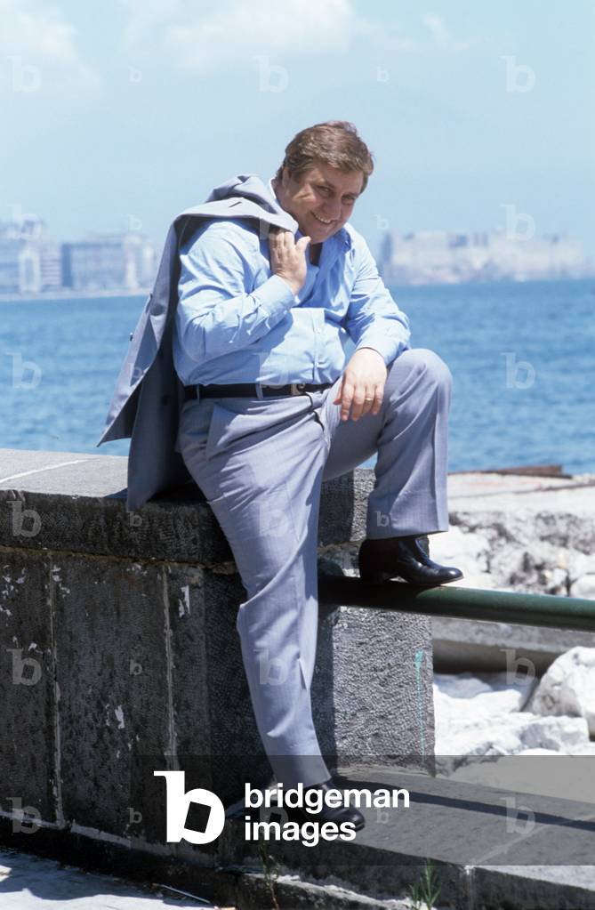 Mario Merola sitting along the seafront