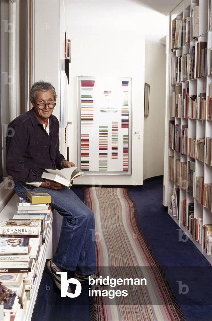Ottavio Missoni browses through a book, Sumirago, Italy