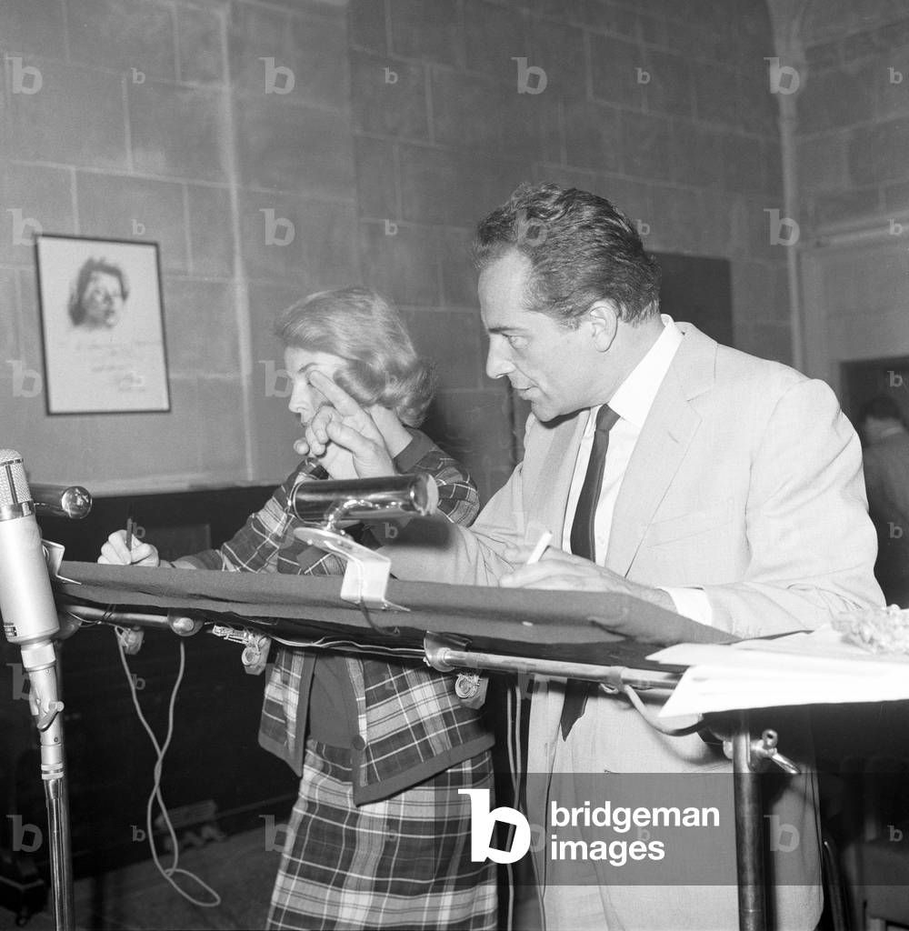 Rossano Brazzi and Anna Proclemer dubbing the film Redhead, Italy, 1962 (b/w photo)