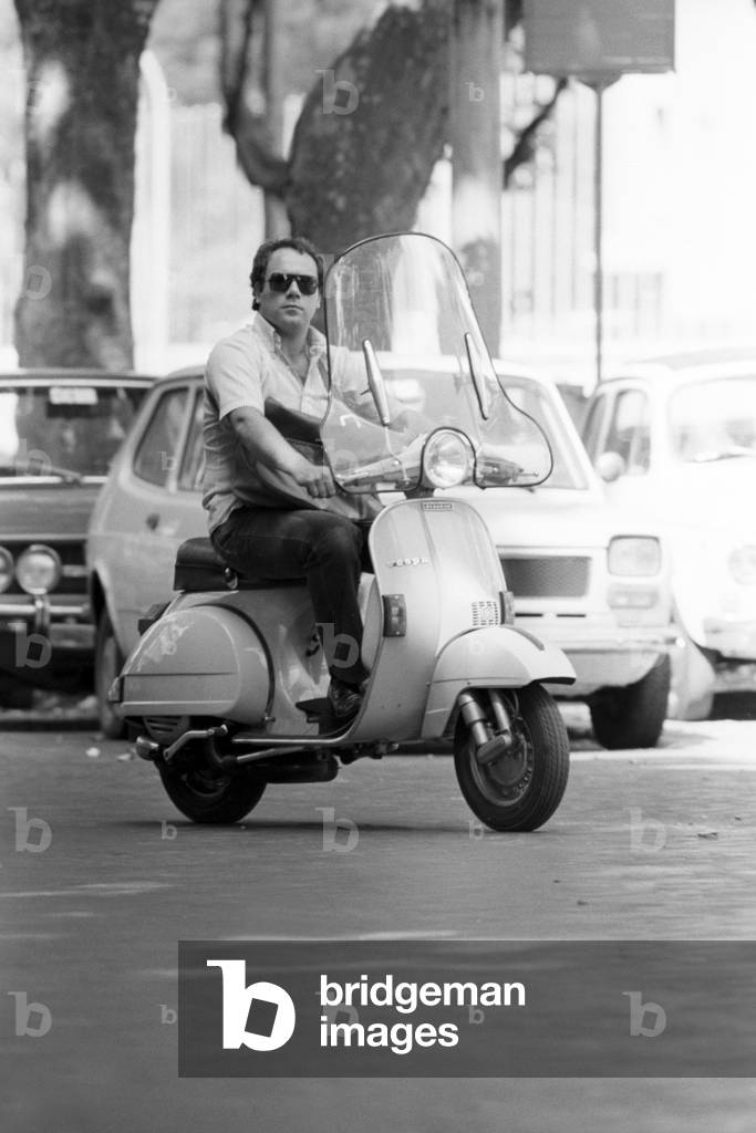 Carlo Verdone riding a vespa, Italy, 1978 (b/w photo)