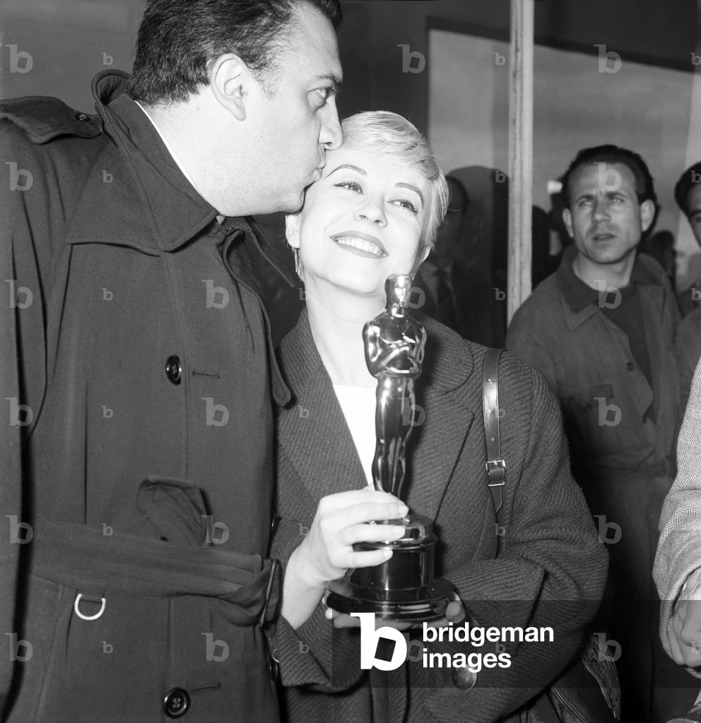 Federico Fellini and Giulietta Masina at Ciampino Airport, Italy, 1957 (b/w photo)