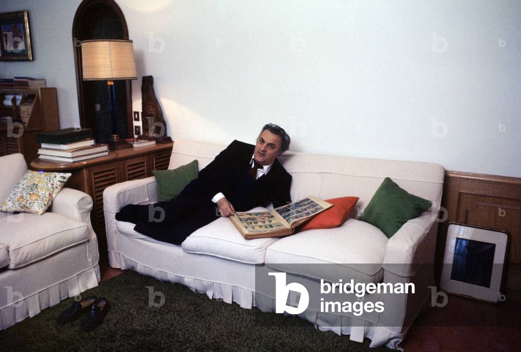 Federico Fellini leafing through an album, Italy, 1969 (photo)