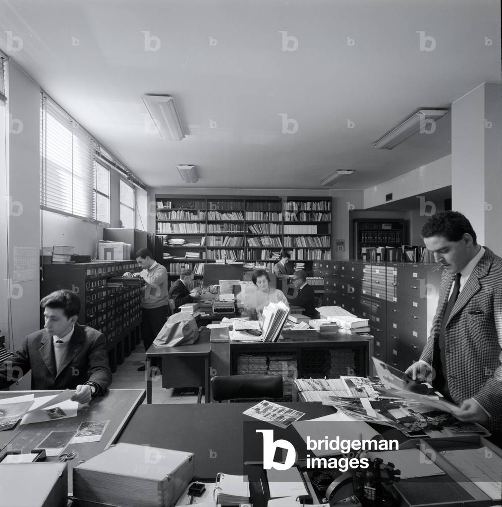 Journalists searching through the Mondadori photograph archive, Milan, Italy