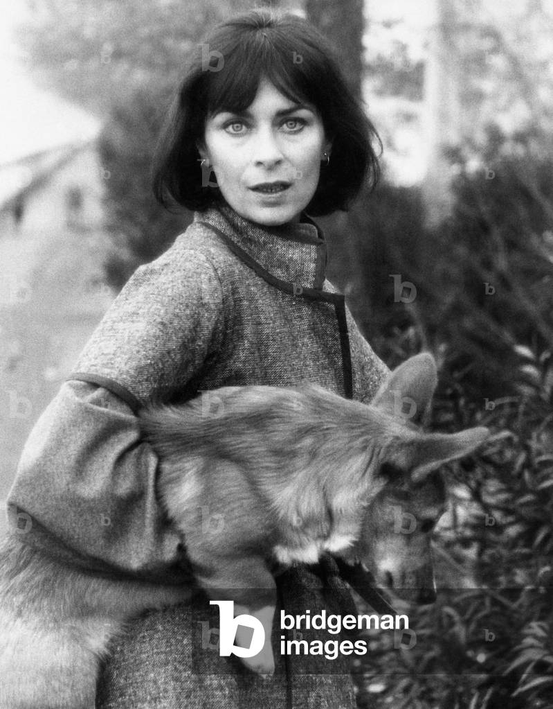 Juliette Mayniel with a dog in her arms