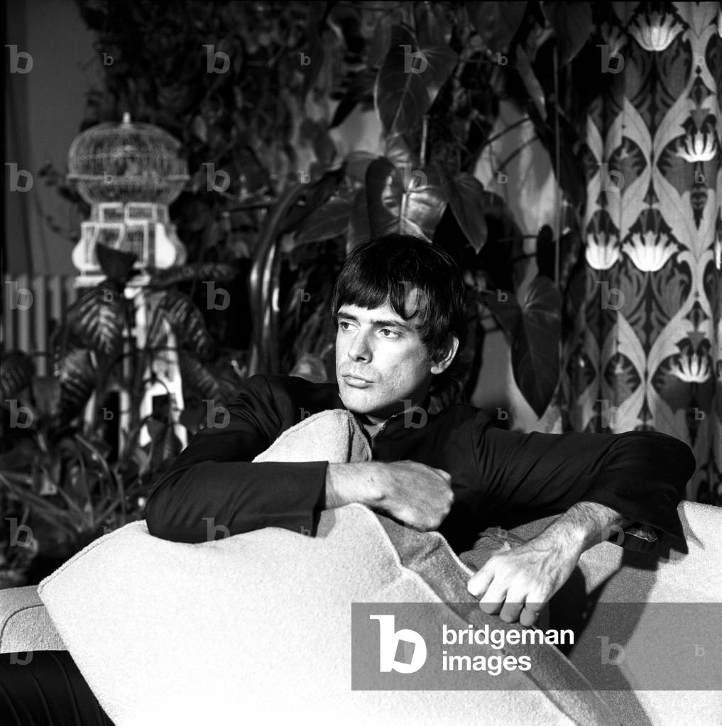 Tomas Milian sitting at home