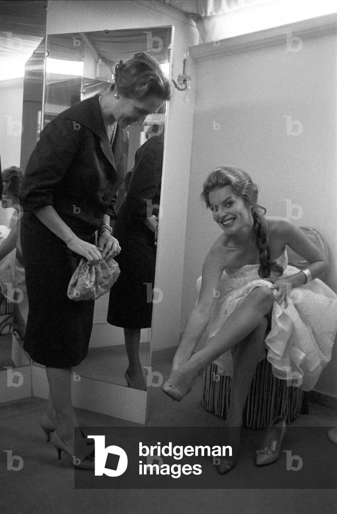 Belinda Lee trying a pair of shoes, Italy, 1956 (b/w photo)