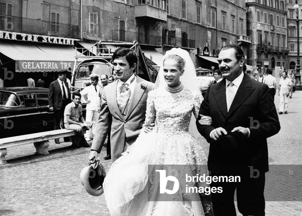 Candice Bergen in a wedding gown accompanied by two men