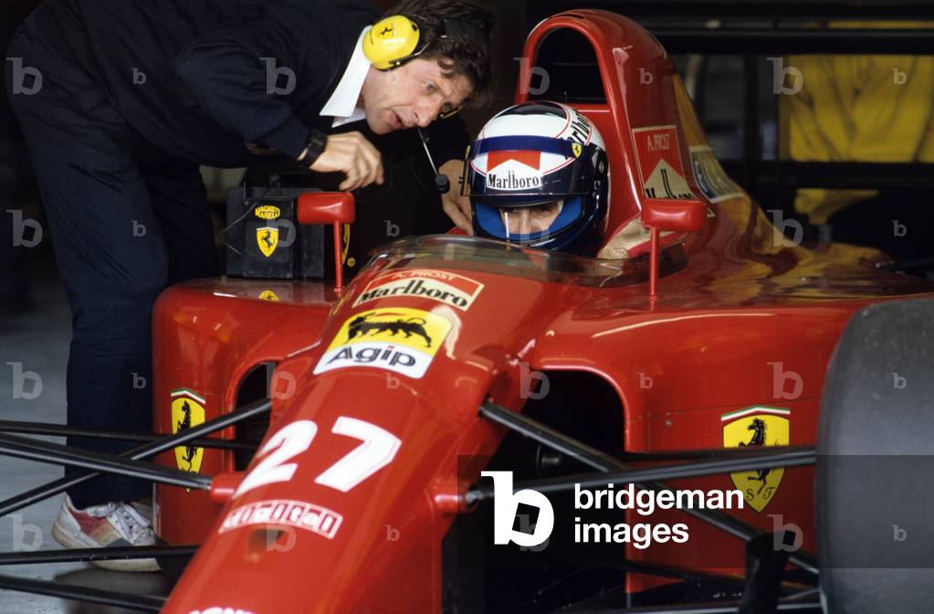 Alain Prost in the passenger compartment of a Ferrari, tests the racing car with a technician