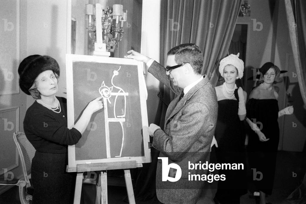 Biki and Alain Reynaud show a picture on a black board
