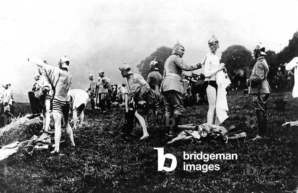 Some soldiers preparing themselves for a bath in the river