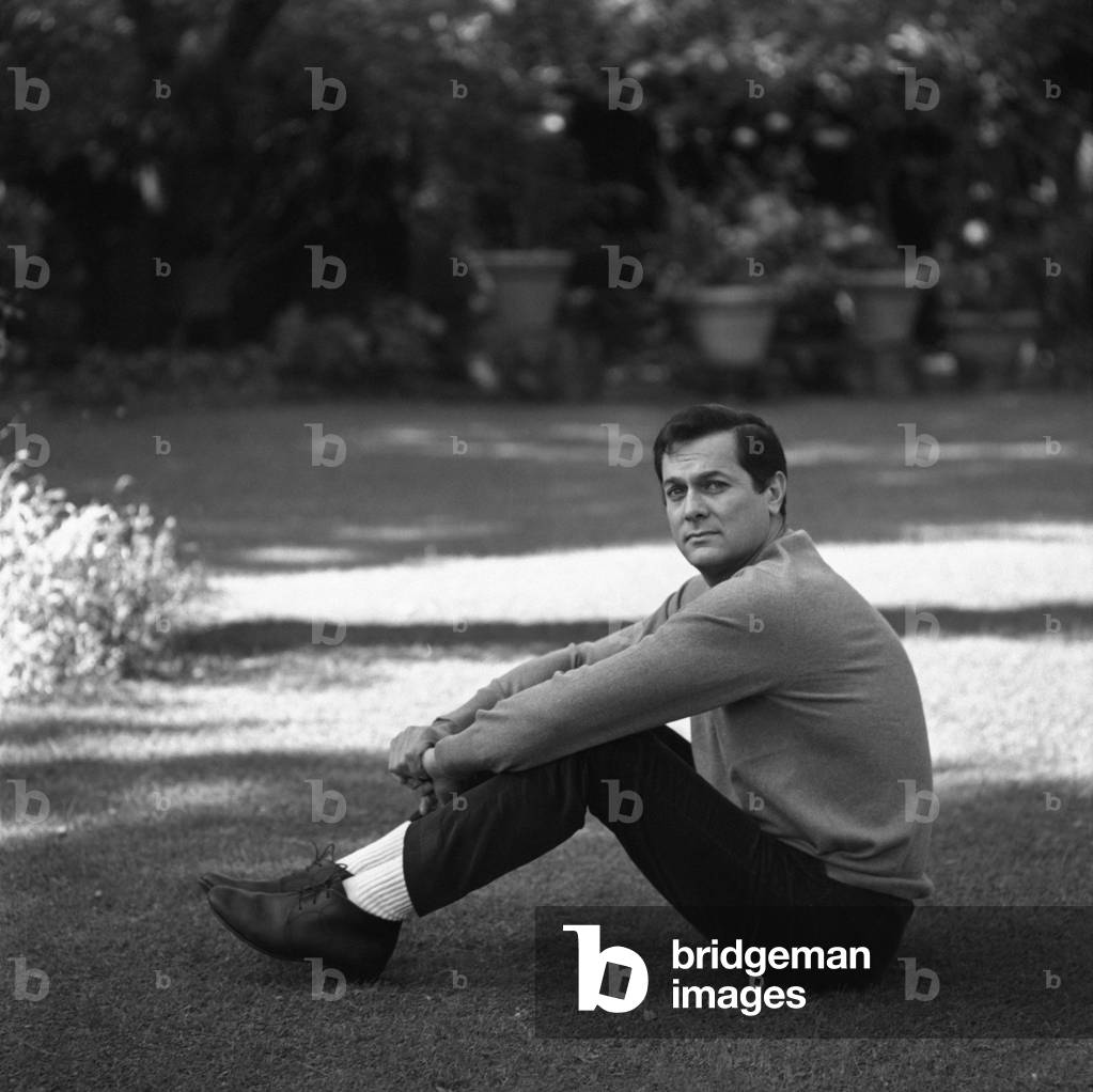 Tony Curtis sitting in the garden of his villa, Rome, Italy