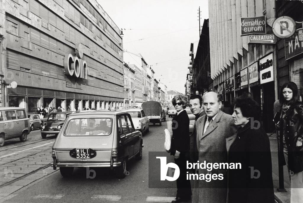 Passers-by waiting to cross the street