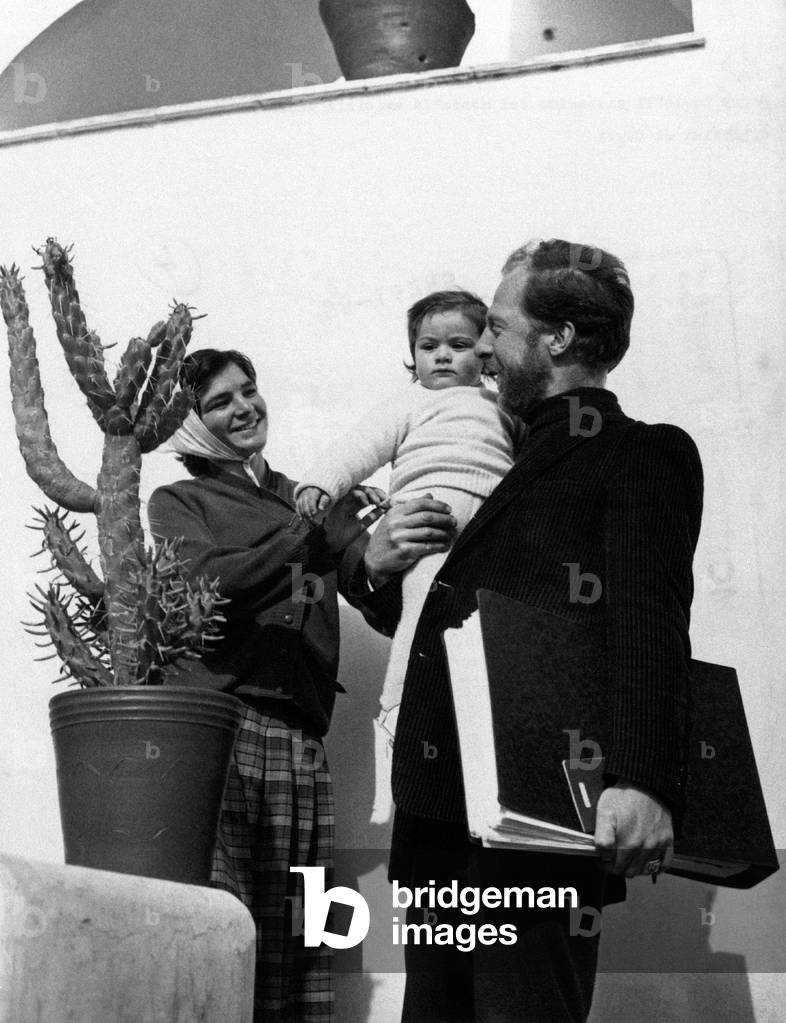 Garry Davis in Capri holding a baby in his arms