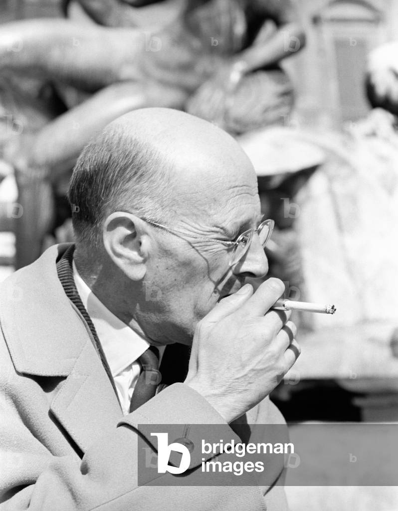 The novelist Andre Chamson smokes a cigarette