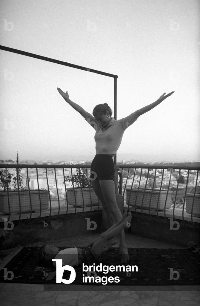 Esther Williams doing exercises on the terrace with her daughter