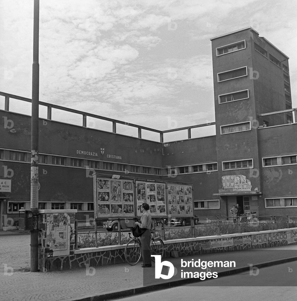 During the regional election in Trentino-Alto Adige/Sudtirol, some electoral posters of the Christian Democratic Party hanging on the building of European Academy of Bolzano, Bolzano, November 1952 (b/w photo)