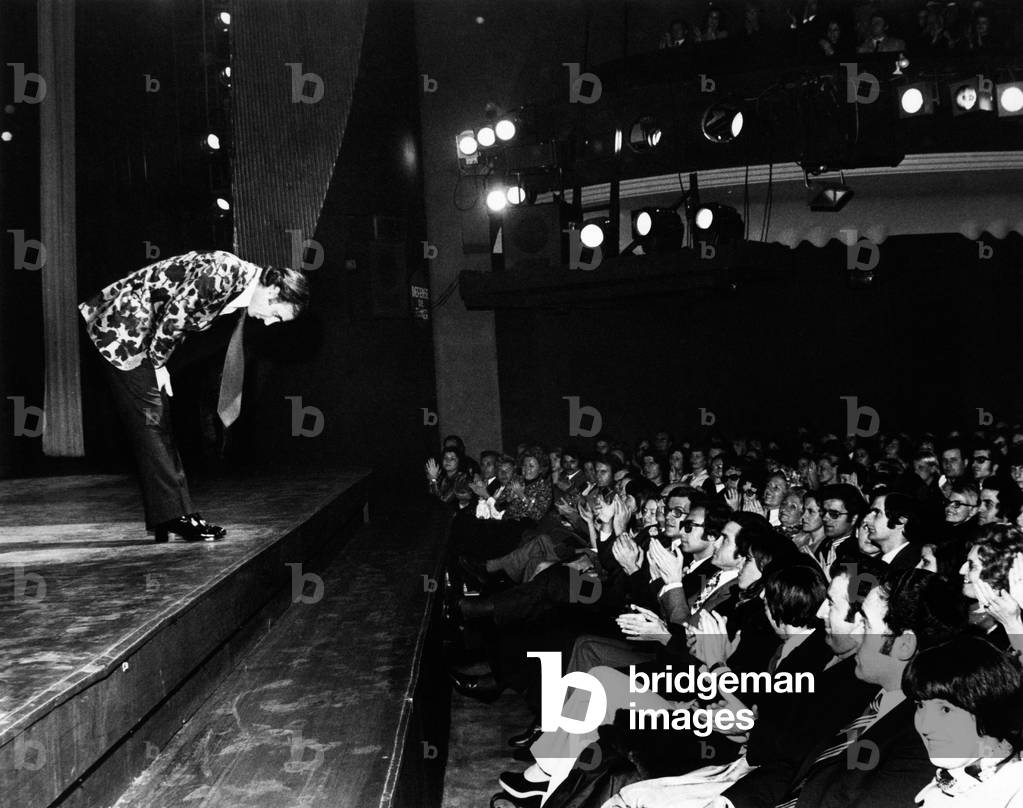 Charles Aznavour bows in fronts of the audience, 1973 (b/w photo)