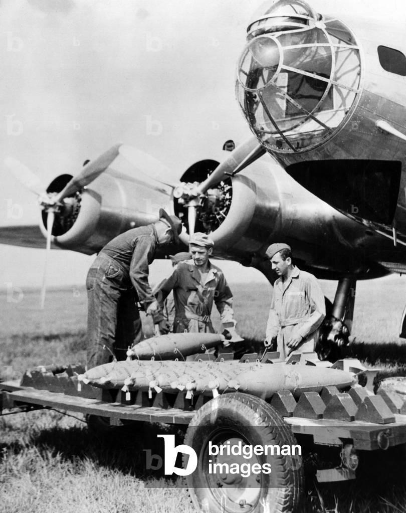 Soldiers loading bombs on a trolley
