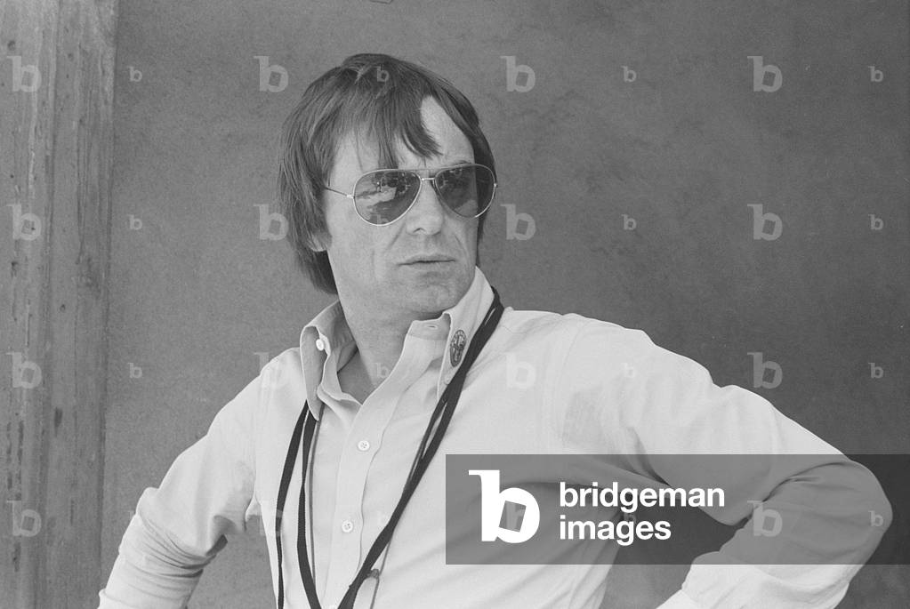 Bernie Ecclestone watching the qualifying sessions of the Italian Gran Prix, Italy, 1977 (b/w photo)