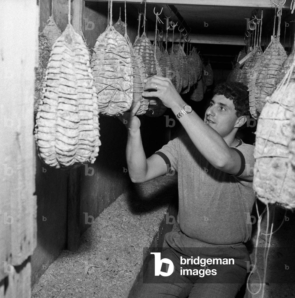 Alberto Guareschi checking some salami