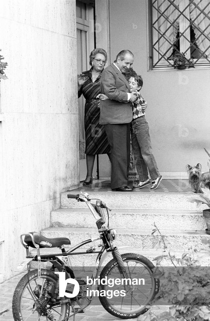 Luigi Lucchini hugging his grandson beside his wife Emilia Rota