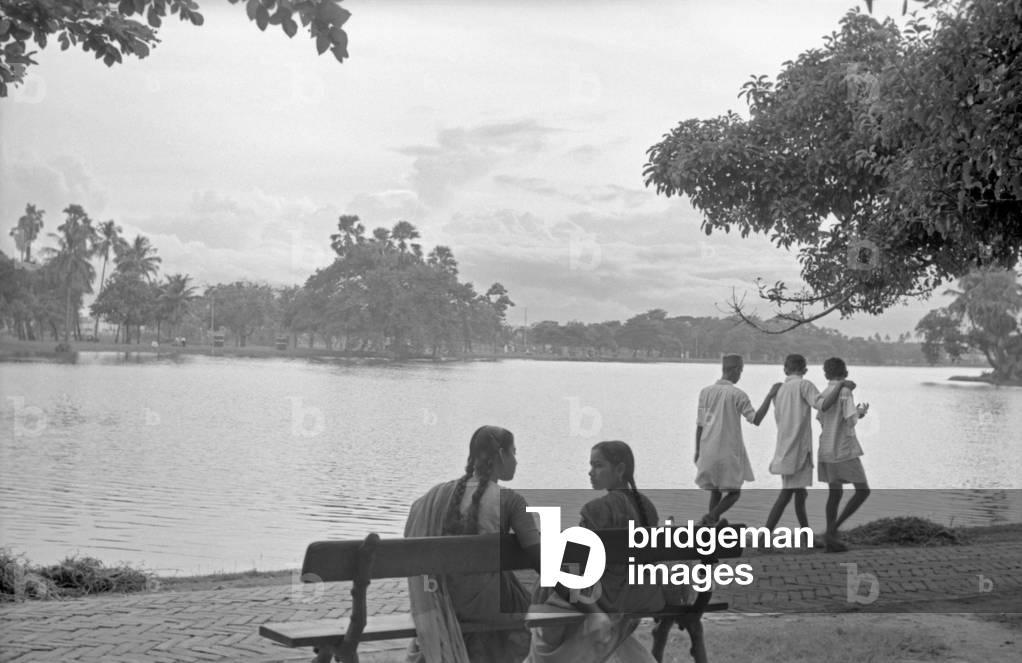 Two girls sitting on a bench, Kolkata, India, 1962 (b/w photo)