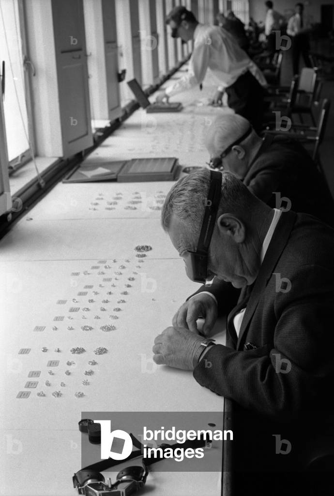 Two men examining the diamonds digged out from a South African mine, Republic of South Africa, 1965 (b/w photo)