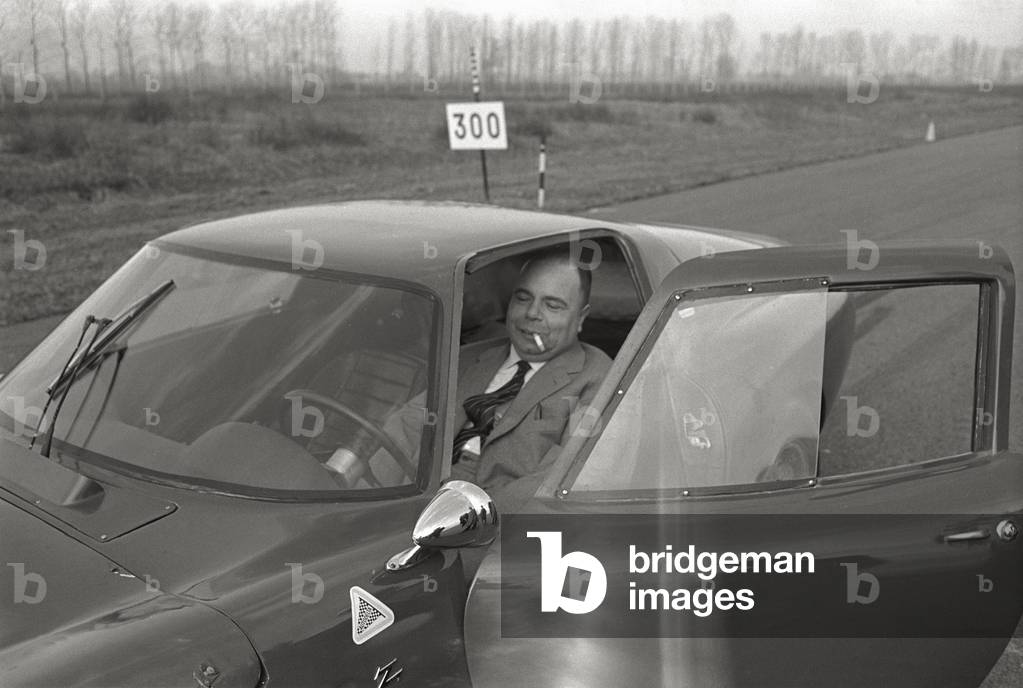 A man in an Alfa Romeo car (b/w photo)