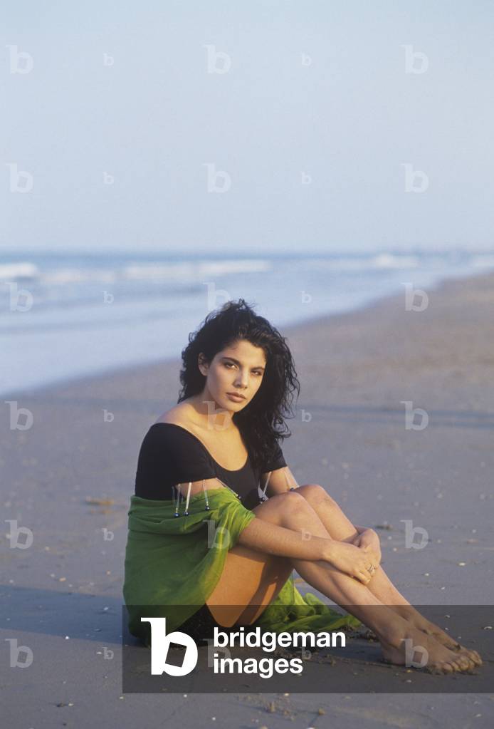 Mietta sitting on the seashore, Italy