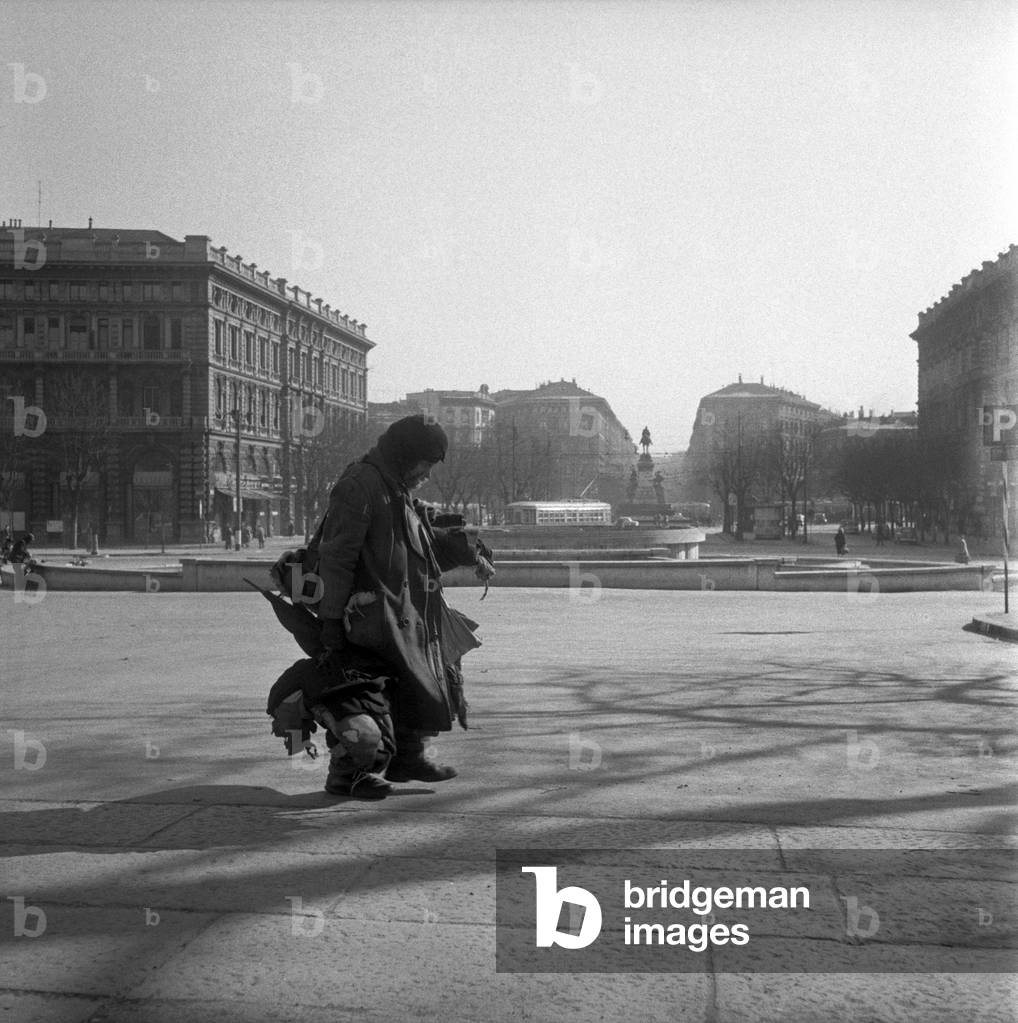 A homeless in piazza Castello,  Milan, Italy