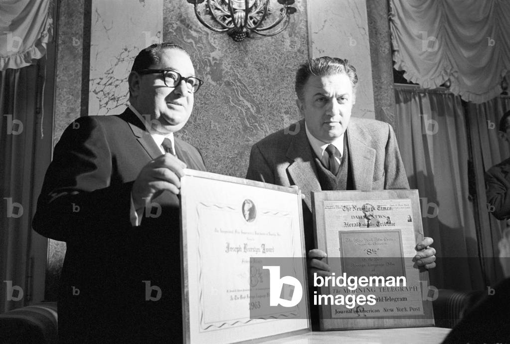 Federico Fellini receiving a prize from Joseph E. Levine, Italy, 1964 (b/w photo)