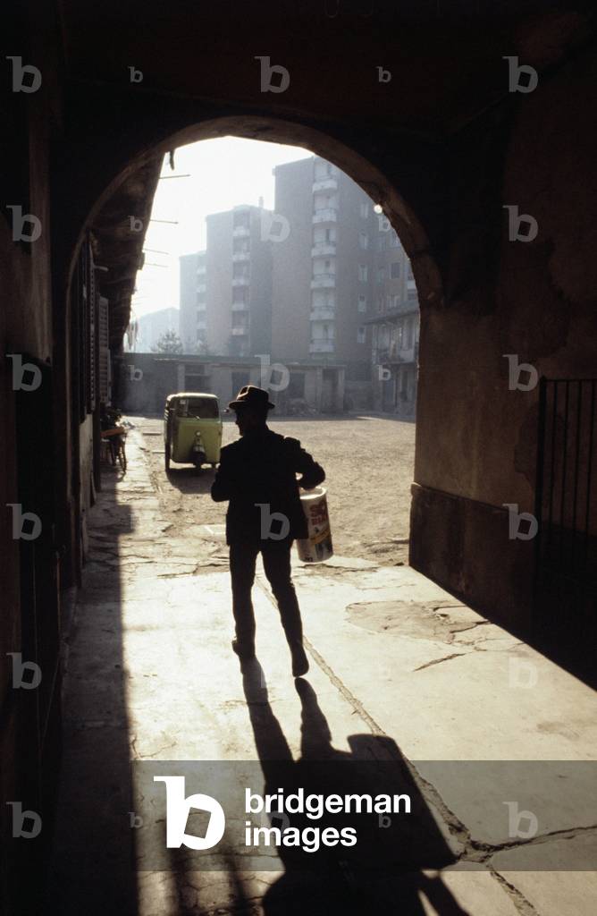 A man walking under a vault, Italy