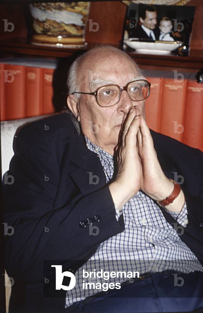 Italian writer Andrea Camilleri covering his mouth, 1999 (b/w photo)