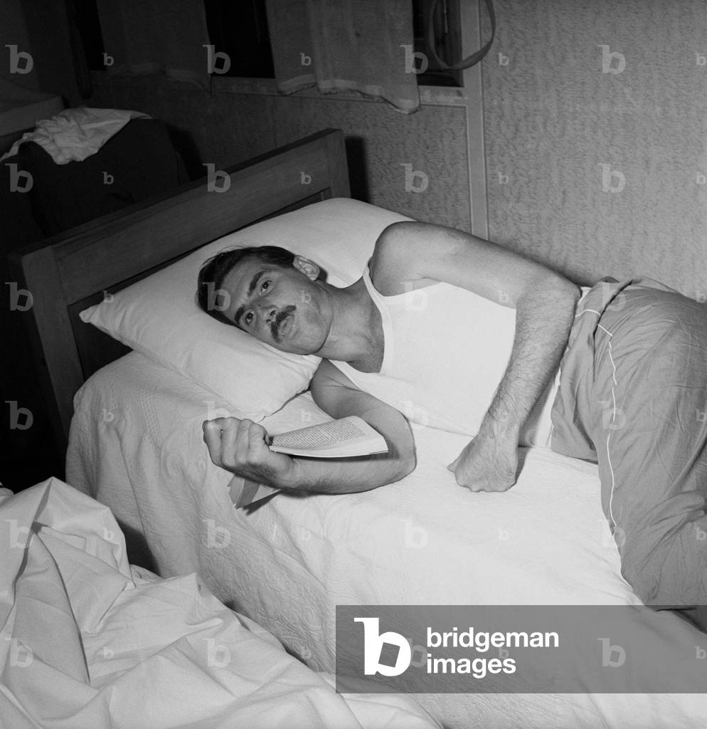 A man lying down on a bed