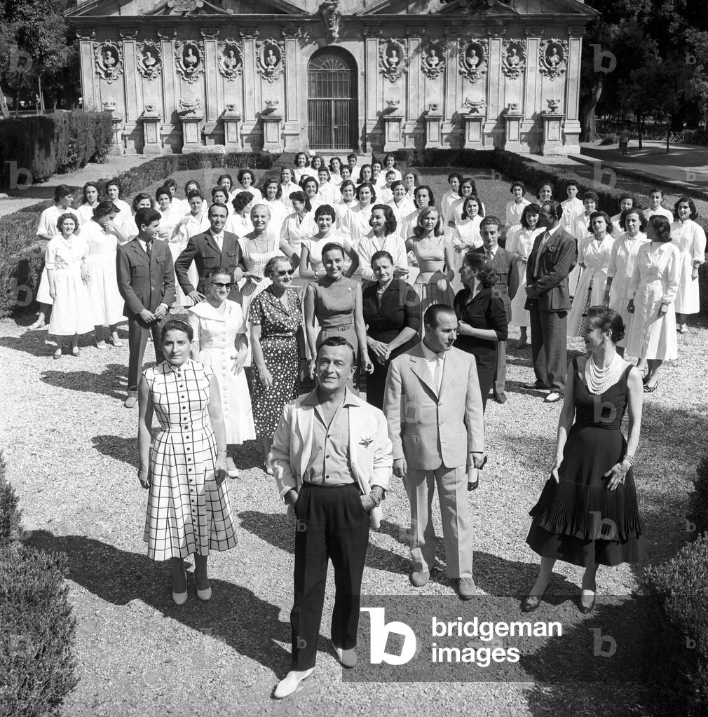 Emilio Schuberth with seamstresses and people working for his fashion house, Italy, 1951 (b/w photo)