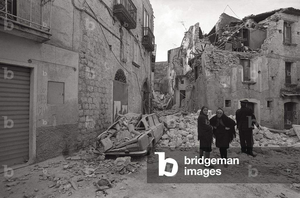 Two women near some rubble after a earthquake, 1980 (b/w photo)