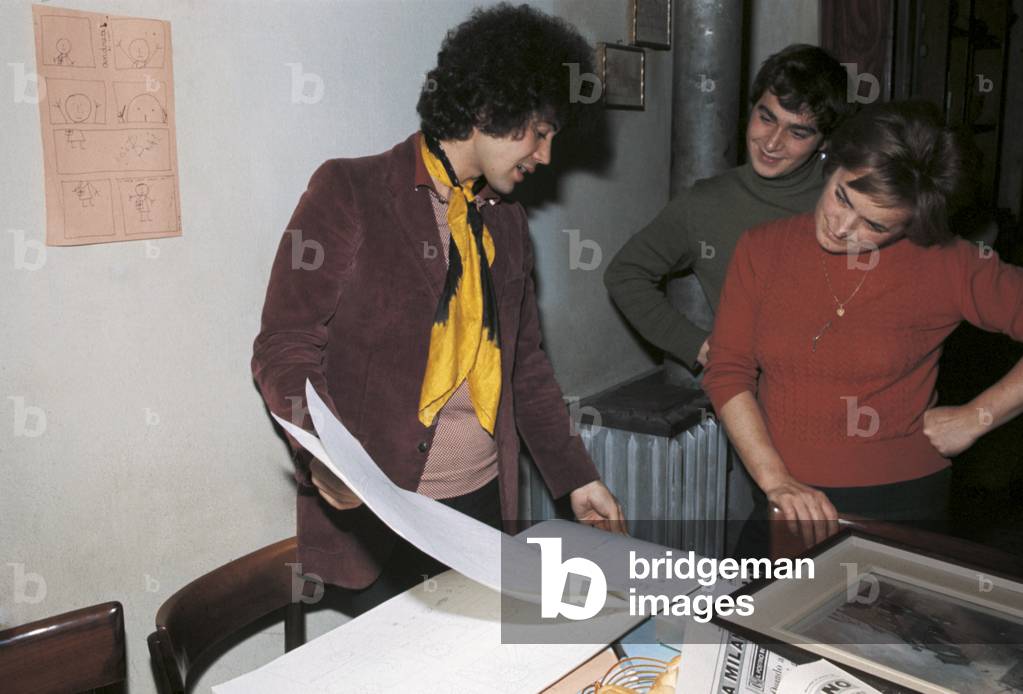 Lucio Battisti showing a drawing book with some of his drawings, Milan, Italy