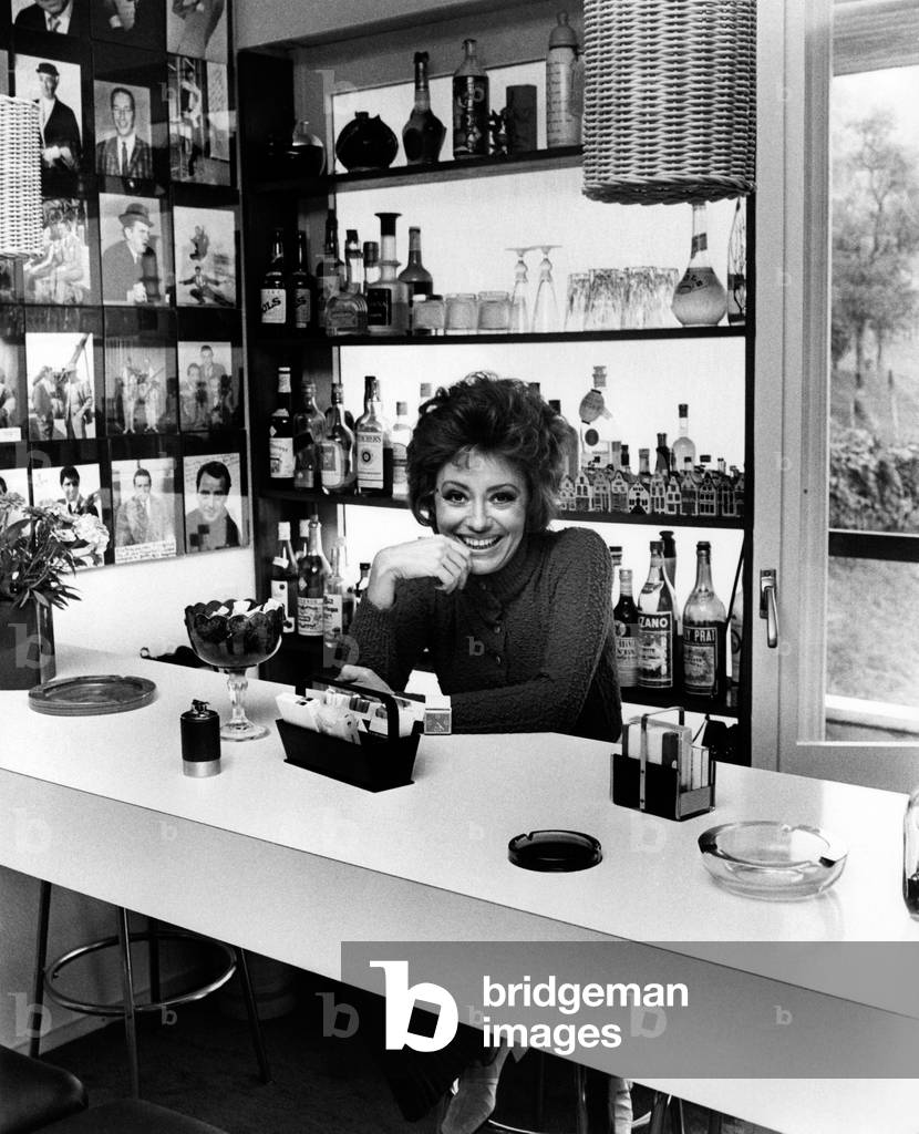 Caterina Valente sitting in the bar area